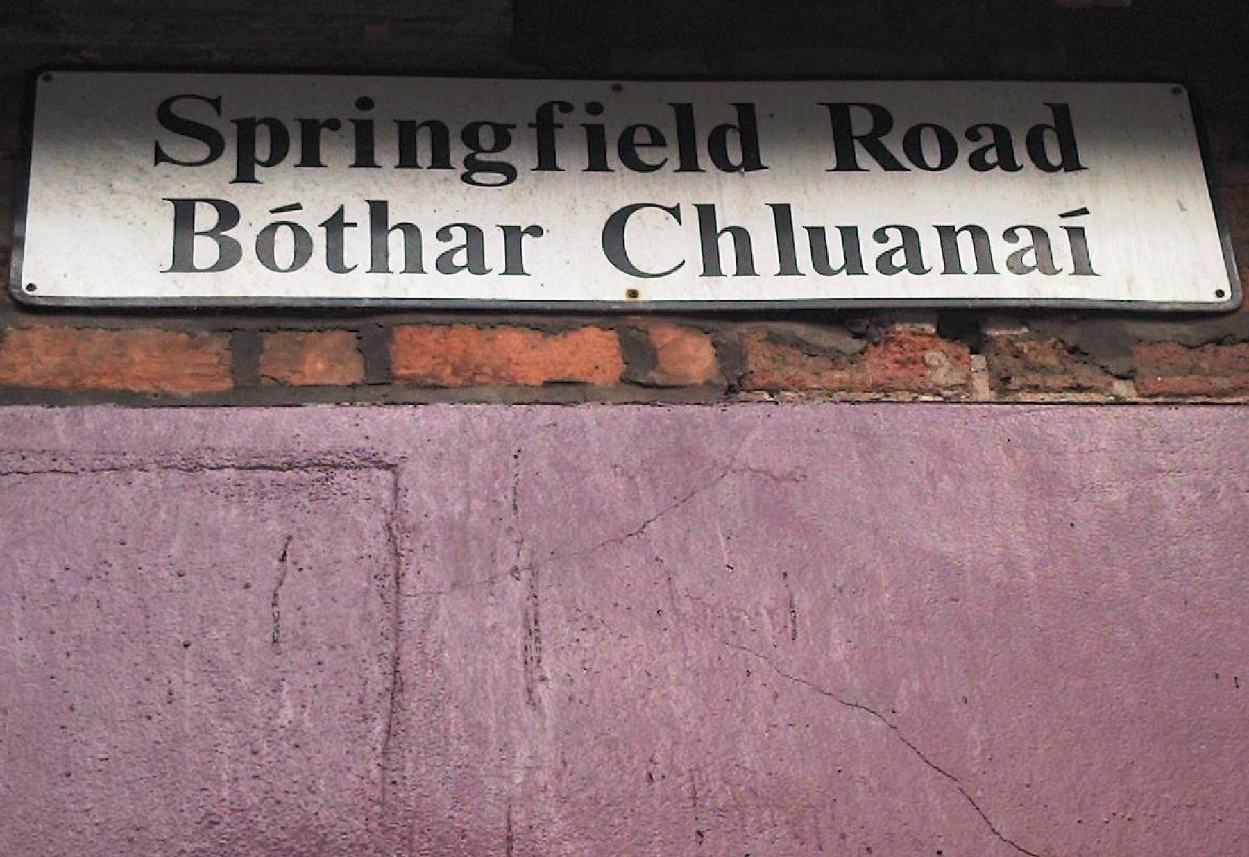 Bilingual English and Irish street sign on Springfield Road in west Belfast