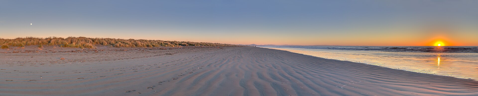Panorama showing both the sun and the moon around the winter solstice (see also June solstice ). South New Brighton's beach, New Zealand