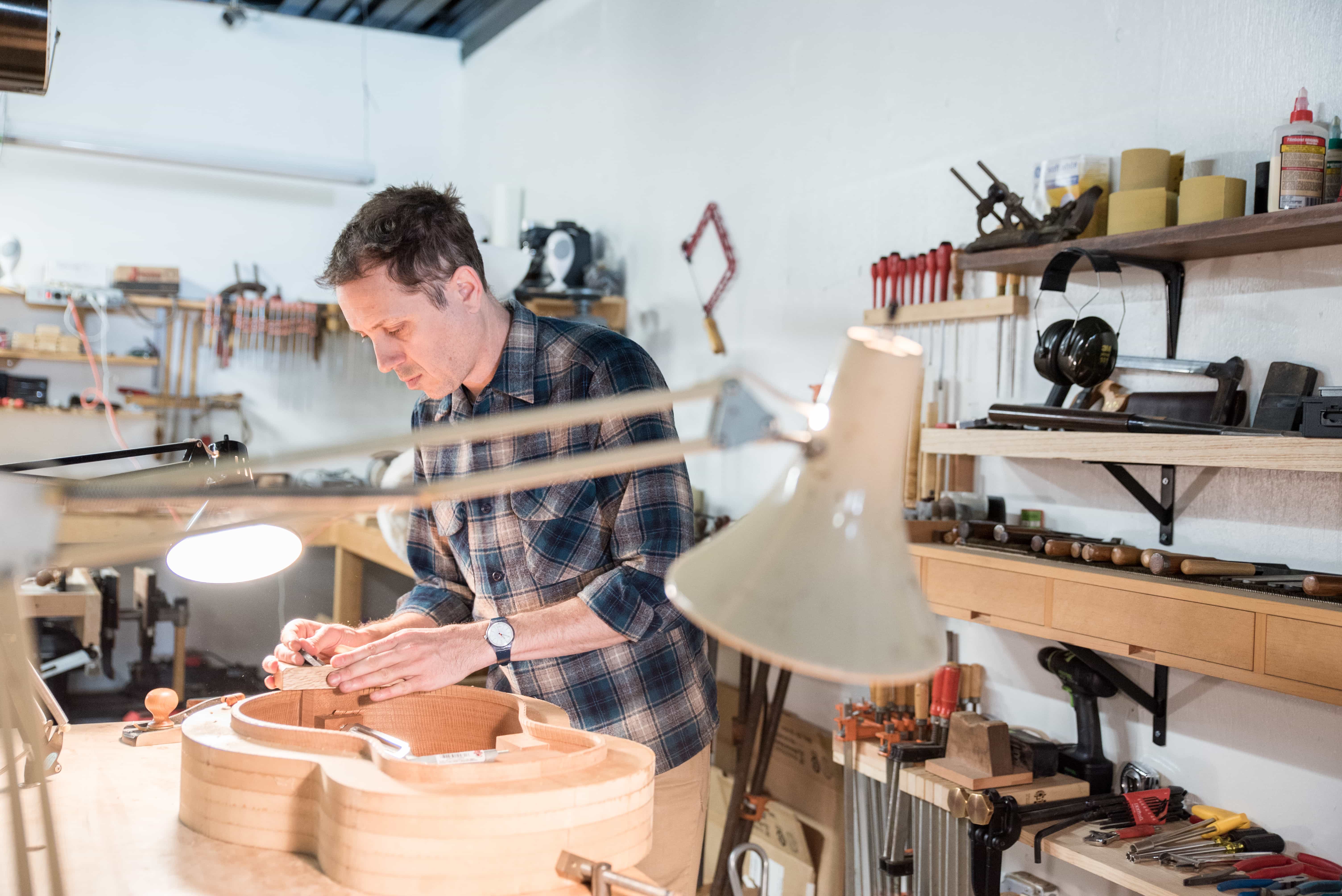 A luthier making a guitar