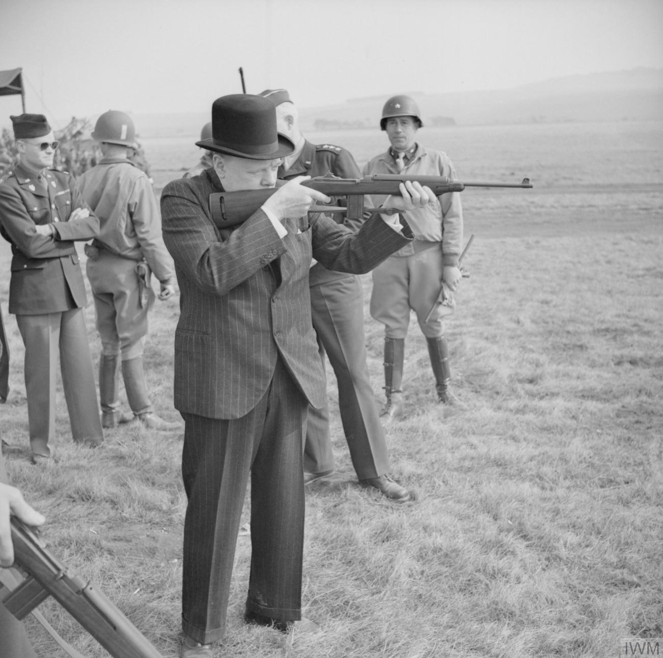 The British Army in the United Kingdom 1939-45 Winston Churchill fires an American .30 carbine during a visit to the US 2nd Armoured Division on Salisbury Plain in Wiltshire , 23 March 1944.